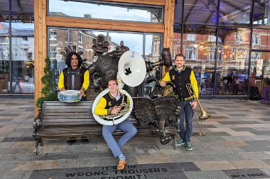 Band sat on Wallace and Gromit bench